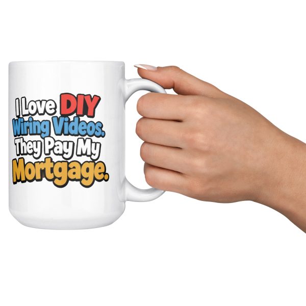 I Love DIY Wiring Videos. They Pay My Mortgage. 15oz electrician mug, held out by the handle 15 oz white ceramic electrician mug printed with "I Love DIY Wiring Videos. They Pay My Mortgage.", held out by the handle
