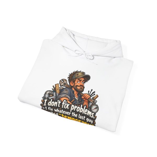 White hoodie printed with "I don't fix problems. I fix whatever the last guy called “temporary.” On the front of a white hoodie, with the smug tech and his duct-taped pipes. For the maintenance tech who inherits every shortcut. Wrench on the shoulder, eyebrows raised.", folded view