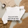 Gas station bathrooms ranked, and social work knows it. Marker crewneck White hand-drawn crewneck sweatshirt with the social work dictionary joke: Knows every gas station bathroom in the county. Has them ranked., folded view