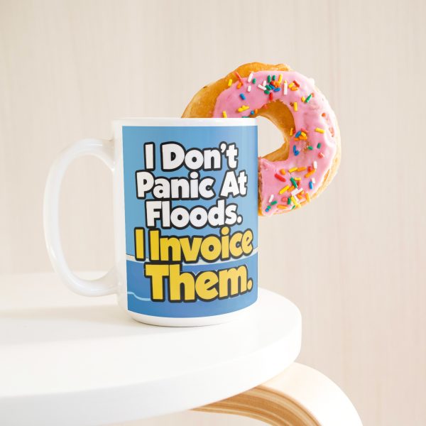 15 oz white ceramic plumber mug printed with "I Don't Panic At Floods. I Invoice Them.", with a donut
