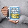 15 oz white ceramic plumber mug printed with "I Don't Panic At Floods. I Invoice Them.", held at chest