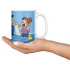 15 oz white ceramic plumber mug printed with "I Don't Panic At Floods. I Invoice Them.", held in an open hand