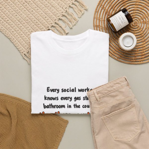 Has every gas station bathroom ranked. Yes, on a hand-drawn social work tee White hand-drawn T-shirt with the social work gas station bathroom ranking joke, folded view