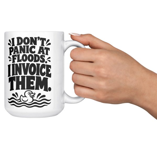 15 oz white ceramic plumber mug printed with "I DON'T PANIC AT FLOODS. I INVOICE THEM.", held out by the handle