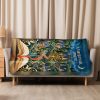 Quiet Village sherpa blanket hung over a sofa in a bright living room Quiet Village sherpa blanket hung over a sofa in a bright living room