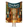 Secret Library sherpa blanket held open by a woman, showing the full ONE BOOK OUT OF PLACE design and its true size