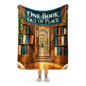 Secret Library sherpa blanket held open by a woman, showing the full ONE BOOK OUT OF PLACE design and its true size