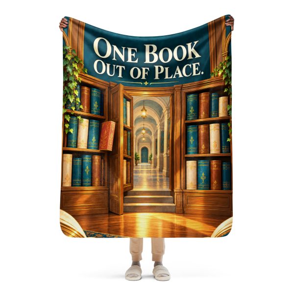 Secret Library sherpa blanket held open by a woman, showing the full ONE BOOK OUT OF PLACE design and its true size