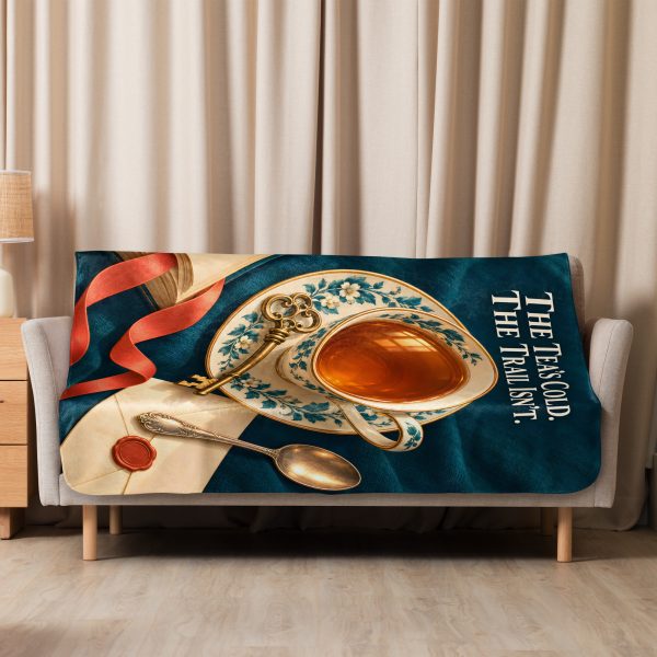 Tea and Books sherpa blanket hung over a sofa in a bright living room