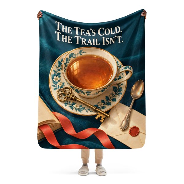 Tea and Books sherpa blanket held open by a woman, showing the full THE TEA'S COLD. THE TRAIL ISN'T design and its true size